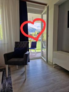 a living room with a heart painted on the window at VIEW APARTMENT in Visoko