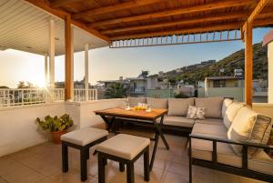 a patio with a couch and a table and chairs at Kusadasi, Villa Simsek in Kusadası