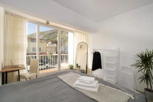 a bedroom with a mirror and a bed with towels at Kusadasi, Villa Simsek in Kusadası