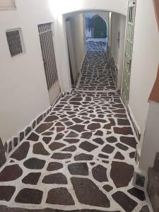 a hallway with a black and white patterned floor at La Cameretta al Porto in Ischia