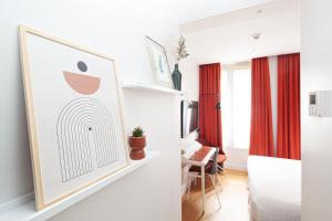a bedroom with a framed picture of an apple at Hôtel Vendome Saint-Germain in Paris