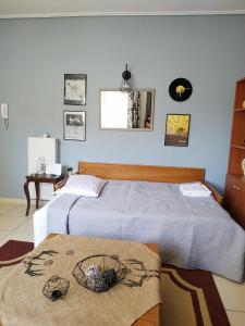 a bedroom with two beds and a table at Adorable Apartment in the center in Volos