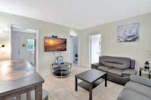 uma sala de estar com um sofá e uma mesa em 2bd cottage style, pets, parking (315E) em Delray Beach