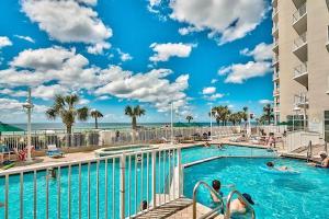 a pool at a resort with people in the water at Majestic Sun 806B in Destin