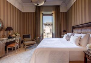a hotel room with a large bed and a window at Anantara Palazzo Naiadi in Rome