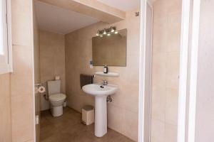 a bathroom with a sink and a toilet at Villa Beso in San Antonio