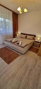 a bedroom with a large bed and a large window at VIEW APARTMENT in Visoko
