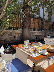 a table with plates of food on top at Sofa Hotels Kaleiçi in Antalya