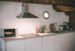 a kitchen with a sink and a stove top oven at Magasin 4 in Gävle