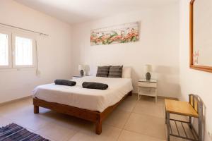 a bedroom with a large white bed in a room at Villa Roberto Ibiza in Sant Josep de sa Talaia