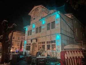a building with blue lights on it at night at Hotel Villa Elisabeth in Ostseebad Sellin