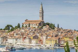 a town on a hill with boats in the water at 2 Bedroom Apartment in Rovinj in Rovinj