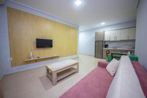 a living room with a couch and a table at Mamma's Apartments in Sarandë +69 photos