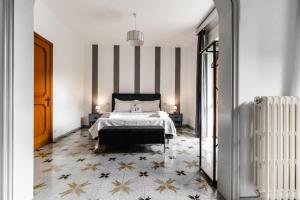 a bedroom with a bed and a striped wall at 2 Santi - Suite and Rooms in Lecce