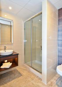 a bathroom with a shower, sink, and toilet at Nox Hotel Galway in Galway