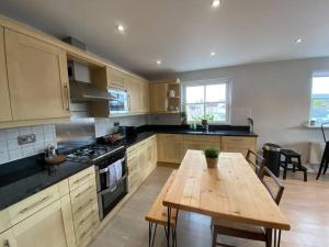 a kitchen with a wooden table and a wooden table sidx sidx sidx at The Penthouse, Winchester in Winchester