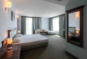 a hotel room with a bed and a mirror at Lion Sunny Beach Hotel in Sunny Beach +31 photos