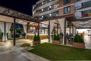 an outdoor patio of a building at night at Lion Sunny Beach Hotel in Sunny Beach