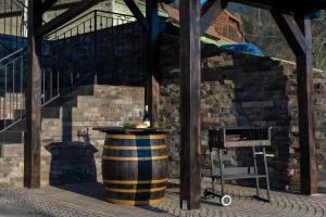 a barrel and a chair in front of a building at Montissimo Chalet in Bran