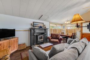 a living room with a couch and a fireplace at Beach Haven in Lincoln City