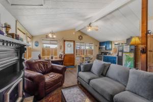 a living room with a couch and a fireplace at Beach Haven in Lincoln City