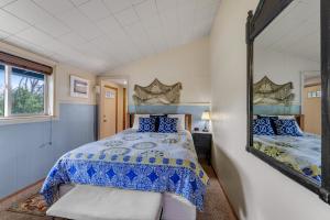 a bedroom with a bed and a mirror at Beach Haven in Lincoln City