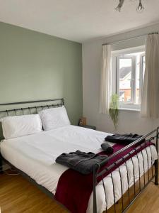 a bedroom with a large bed with towels on it at Manchester 2 Bedroom House with Garden in Manchester