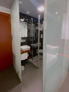 bagno con lavandino e specchio di Hotel Oceano a Nazaré