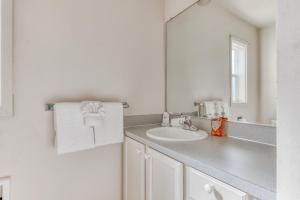 a white bathroom with a sink and a mirror at Seaside Governor's House Vacation Rental in Seaside +43 photos