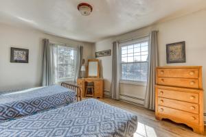 a bedroom with a bed and a dresser and a window at Seaside Governor's House Vacation Rental in Seaside
