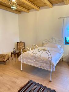 a bedroom with a white bed in a room at Hotel Kaso Ervehe in Përmet +27 photos