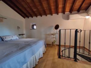 a bedroom with a large bed and a wooden floor at Il Fienile tra gli Ulivi in Lamporecchio