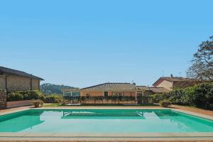 a large swimming pool in front of a house at Villa Melangola in Camaiore