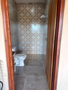 a bathroom with a toilet and a shower at Chacara Usina D Agua - Socorro-SP in Socorro
