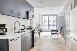 a kitchen with a sink and a counter top at NoMa 1br w wd concierge gym nr Metro WDC-645 in Washington