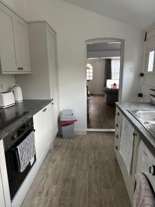 a kitchen with white cabinets and a counter top at 14 crouch road in Burnham-on-Crouch