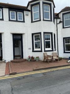 a house with a bench in front of it at No 4 Portpatrick B&B in Portpatrick +11 photos