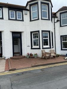 a house with a bench in front of it at No 4 Portpatrick B&B in Portpatrick