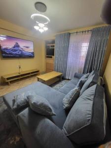 a living room with a couch with pillows on it at Blue House 2 Bedroom House. in Naivasha