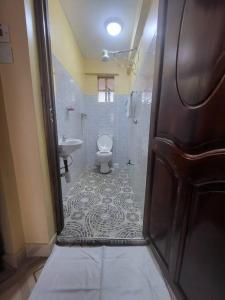 a bathroom with a shower and a toilet and a sink at Blue House 2 Bedroom House. in Naivasha