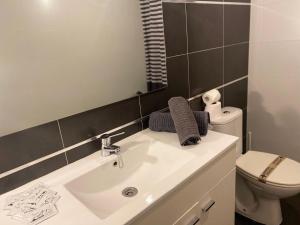 a bathroom with a sink and a toilet and a mirror at Casa Latre Somontano in Barbastro