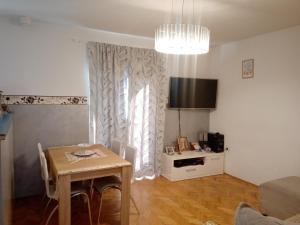 a living room with a table and a dining room at Hostel Olea in Podgorica