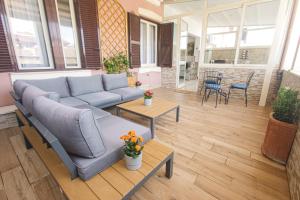 a living room with a couch and a table at Hotel Terrazza Magenta in Rome