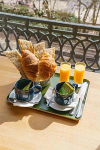 a tray of bread and two glasses of orange juice at Hotel du Théatre in Lyon