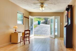 a living room with a desk and a ceiling fan at Pet-Friendly Black Mountain Vacation Home with Deck in Black Mountain