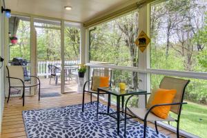 a screened porch with a glass table and chairs at Pet-Friendly Black Mountain Vacation Home with Deck in Black Mountain