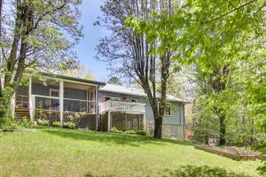 an exterior view of a house with a yard at Pet-Friendly Black Mountain Vacation Home with Deck in Black Mountain