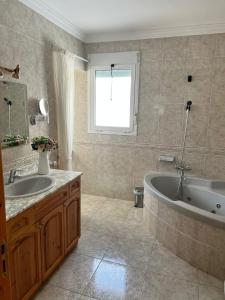 a bathroom with a tub and a sink at Chalet con piscina privada in Vinarós