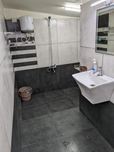 a bathroom with a sink and a shower at Multiple Stories, Wayanad in Wayanad