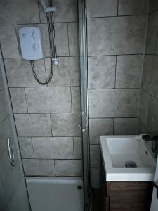 a bathroom with a shower and a sink at Cairo Street in Warrington